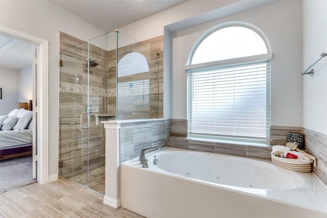 bathroom featuring vanity and independent shower and bath