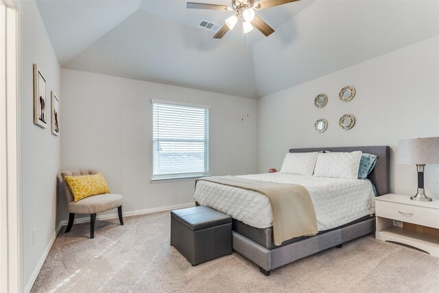 carpeted bedroom featuring vaulted ceiling, ceiling fan, and ensuite bath