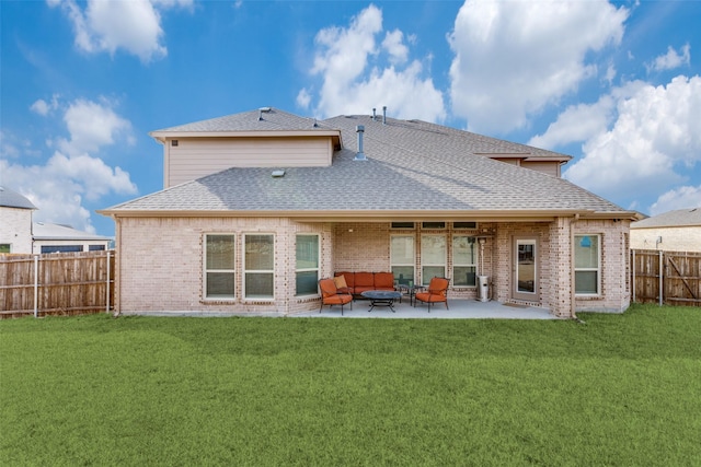 back of house with a shingled roof, a lawn, a patio, a fenced backyard, and brick siding