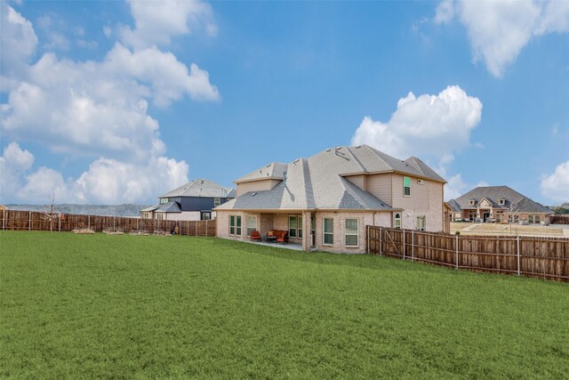 back of house featuring an outdoor hangout area, a yard, and a patio area