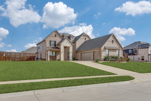 view of front of home with a garage and a front lawn