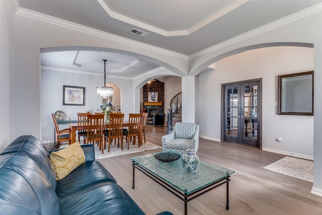 entrance foyer with wood-type flooring, a notable chandelier, and crown molding