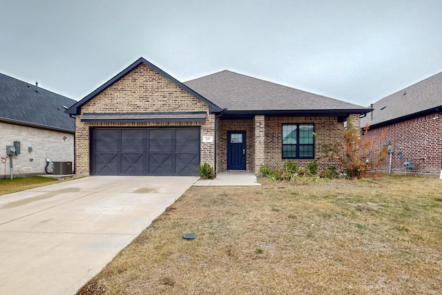 view of front of home with a garage, a front yard, and central air condition unit