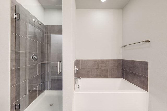 bathroom with separate shower and tub