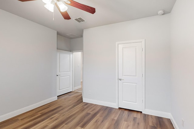 spare room with hardwood / wood-style flooring and ceiling fan