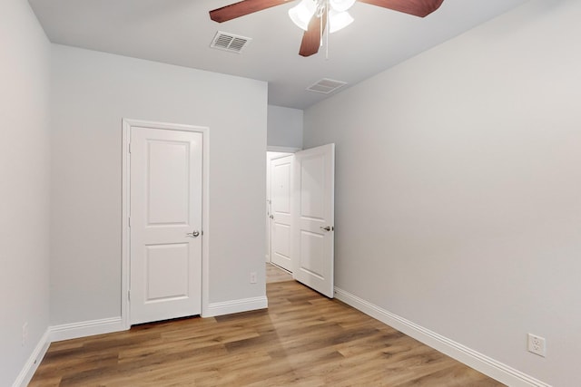 unfurnished bedroom with ceiling fan and light wood-type flooring