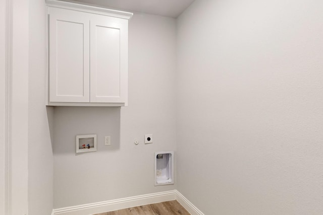 laundry room featuring hookup for a washing machine, cabinets, light hardwood / wood-style floors, hookup for a gas dryer, and hookup for an electric dryer