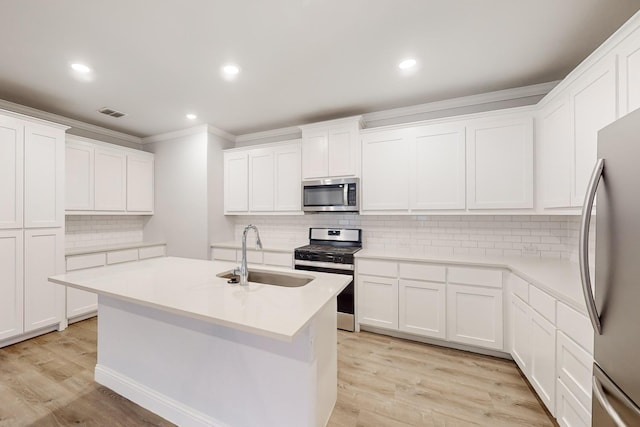 kitchen with stainless steel appliances, sink, and white cabinets