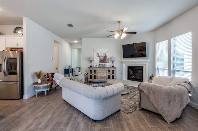 living room featuring hardwood / wood-style floors and ceiling fan