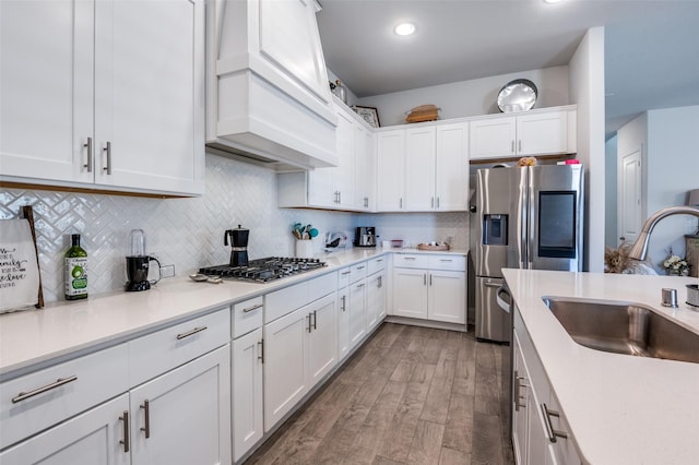 kitchen featuring appliances with stainless steel finishes, sink, decorative backsplash, and white cabinets