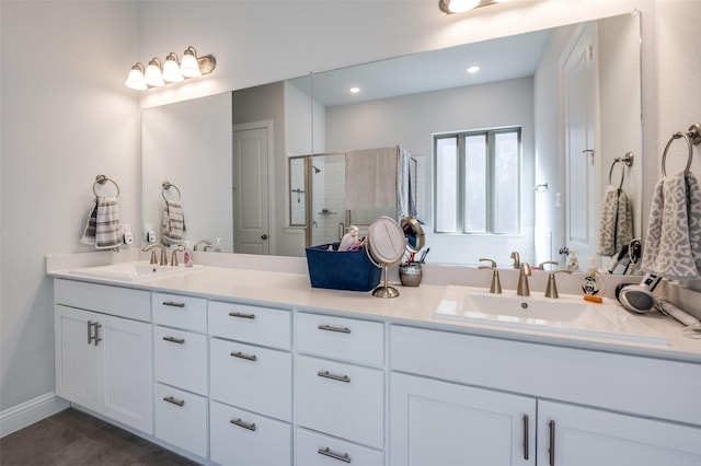 bathroom with tile patterned floors, vanity, and a shower with shower door