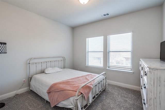 bedroom featuring dark colored carpet