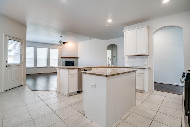 kitchen featuring white cabinetry, dishwasher, and a kitchen island