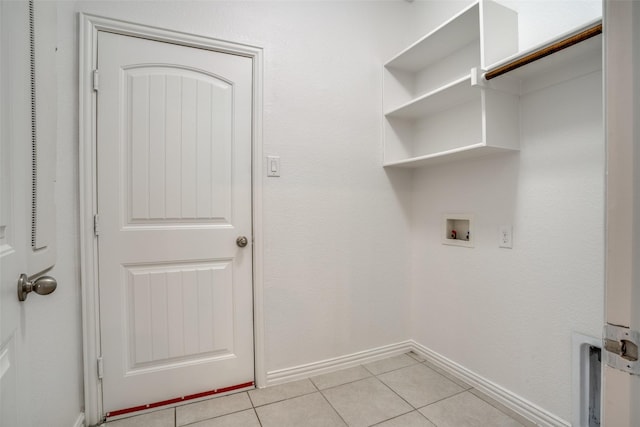 laundry room with washer hookup and light tile patterned flooring