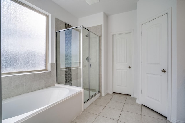 bathroom featuring tile patterned flooring and independent shower and bath