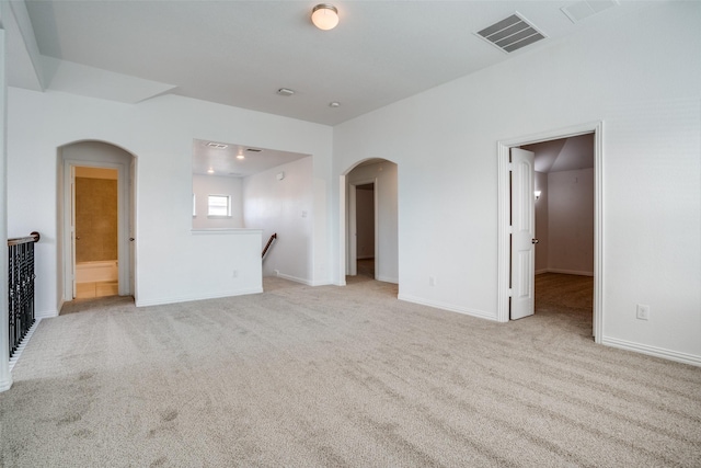 unfurnished living room featuring light carpet