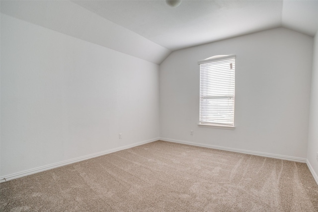 bonus room with carpet floors and vaulted ceiling