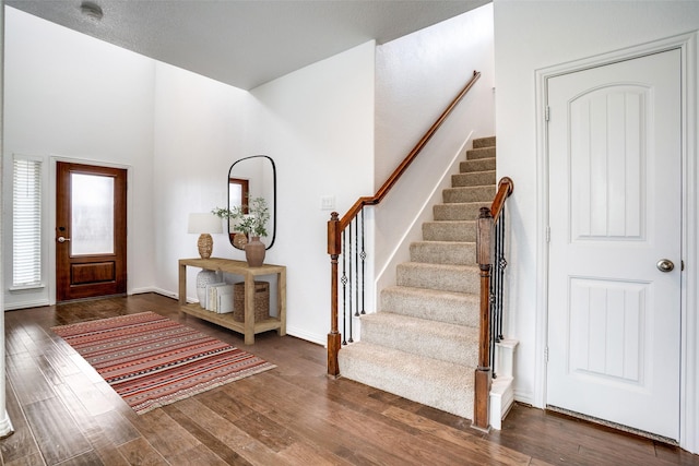 foyer entrance featuring dark wood-type flooring