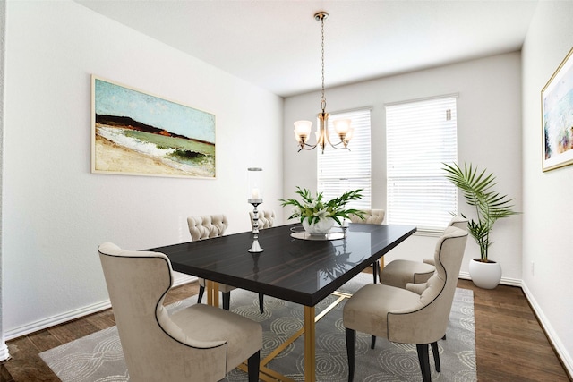 dining area with an inviting chandelier and dark hardwood / wood-style floors