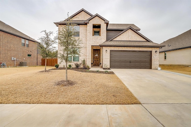 view of front of property with a garage and central AC