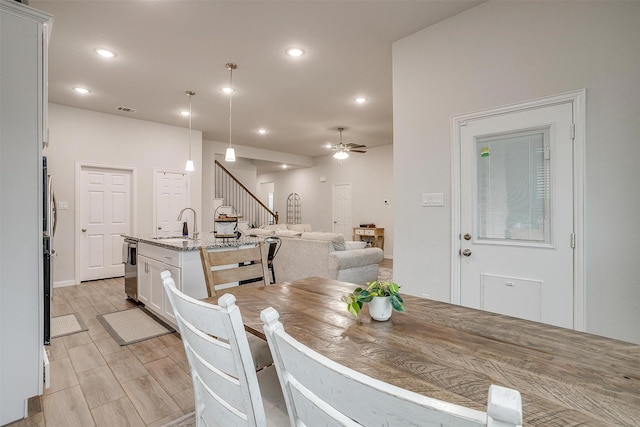 dining space with sink and ceiling fan