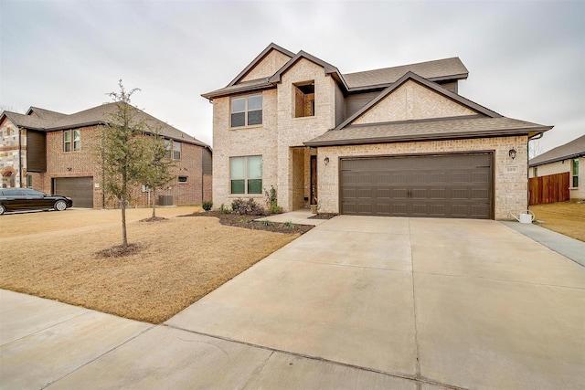 view of front of property with a garage and cooling unit