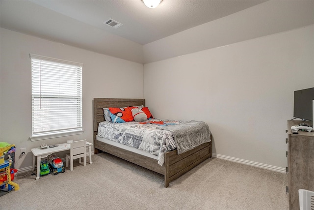 carpeted bedroom featuring multiple windows