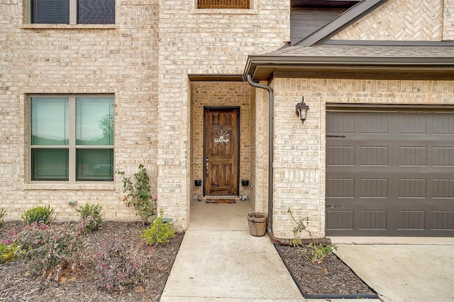 view of exterior entry with a garage