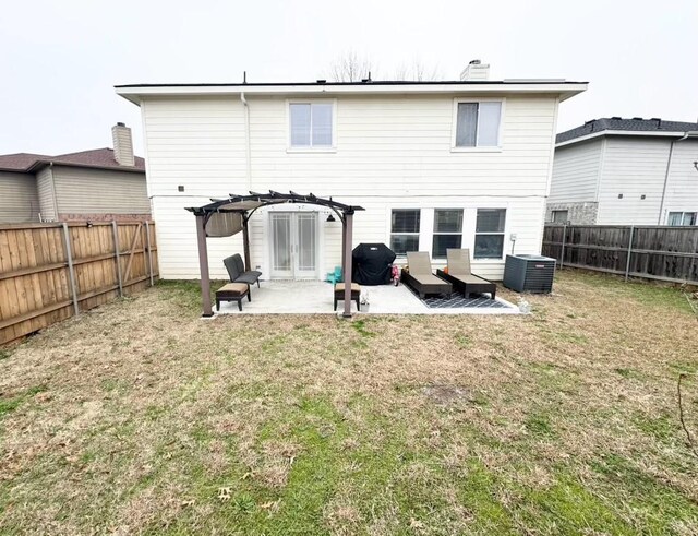 rear view of house with a yard, a patio area, central air condition unit, and a pergola