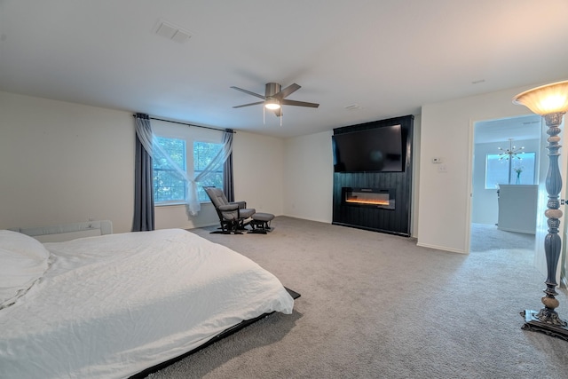 7935 Faithful Trl, Dallas, TX 75237 - bedroom with visible vents, baseboards, ceiling fan, a large fireplace, and carpet flooring