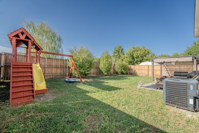 view of yard featuring central AC and a playground