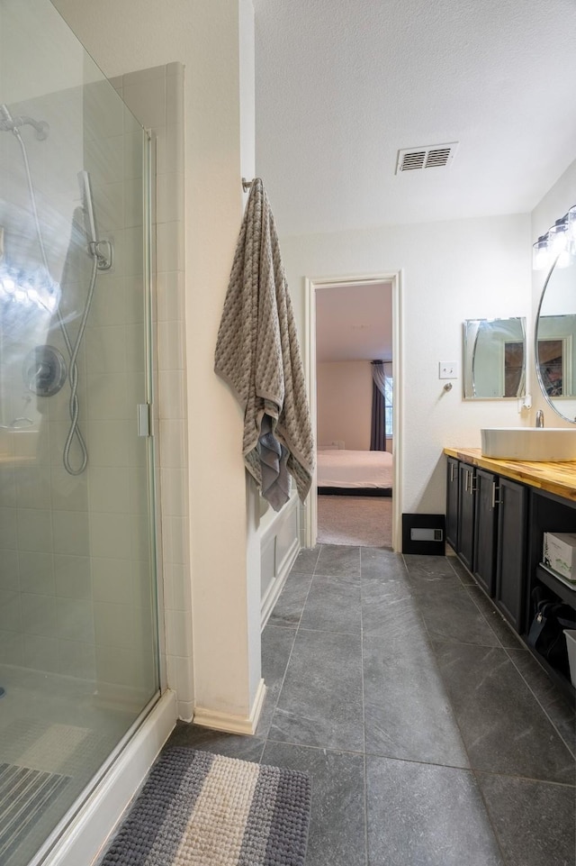 7935 Faithful Trl, Dallas, TX 75237 - bathroom featuring visible vents, baseboards, a shower stall, and vanity