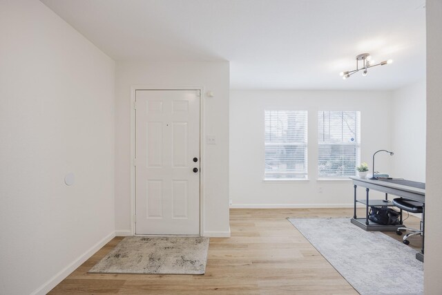 7935 Faithful Trl, Dallas, TX 75237 - entrance foyer with light wood-style floors and baseboards