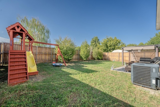 7935 Faithful Trl, Dallas, TX 75237 - view of yard with central AC unit, a fenced backyard, and a playground