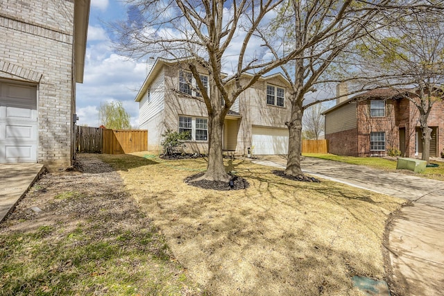 7935 Faithful Trl, Dallas, TX 75237 - traditional-style house with an attached garage, concrete driveway, and fence