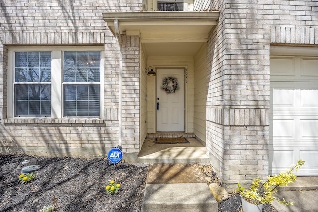 7935 Faithful Trl, Dallas, TX 75237 - view of exterior entry with a garage, brick siding, and stone siding