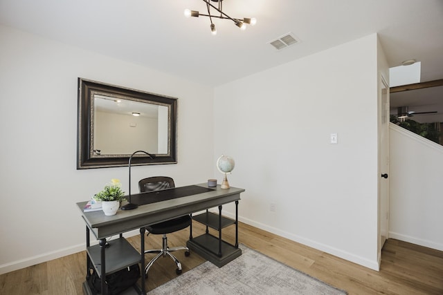 7935 Faithful Trl, Dallas, TX 75237 - office area featuring visible vents, baseboards, an inviting chandelier, and wood finished floors