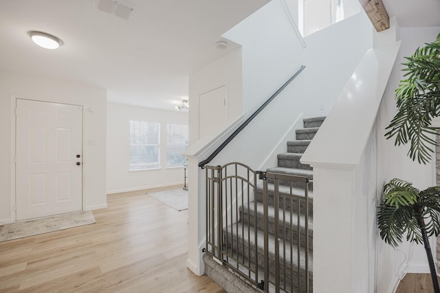 7935 Faithful Trl, Dallas, TX 75237 - foyer featuring light wood-style flooring, baseboards, visible vents, and stairway