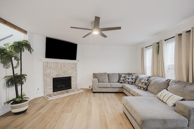 7935 Faithful Trl, Dallas, TX 75237 - living room featuring light wood finished floors, a fireplace, a ceiling fan, and baseboards