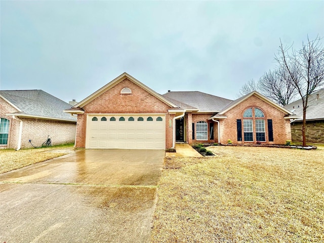 view of front of property featuring a garage and a front lawn