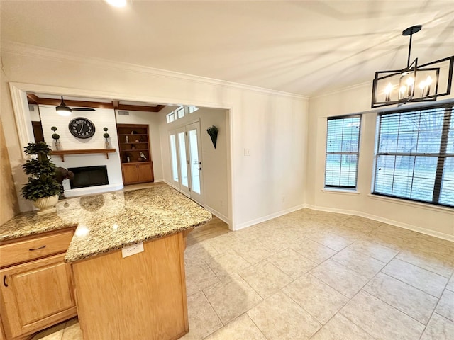 kitchen featuring light stone counters, decorative light fixtures, crown molding, and kitchen peninsula