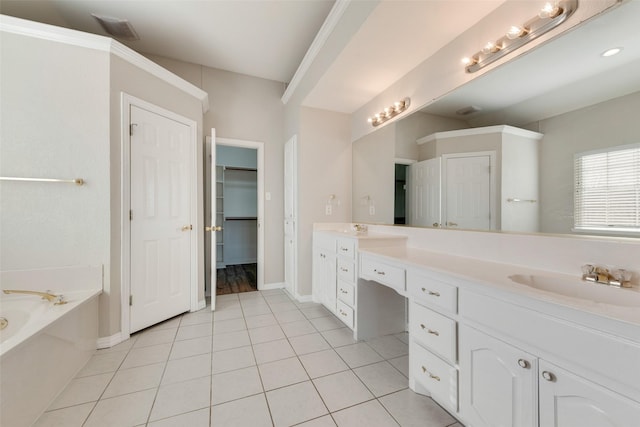 bathroom featuring a bathing tub, vanity, and tile patterned floors