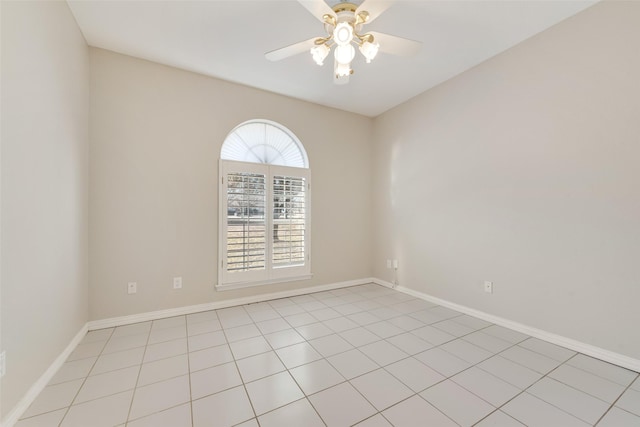 tiled spare room featuring ceiling fan