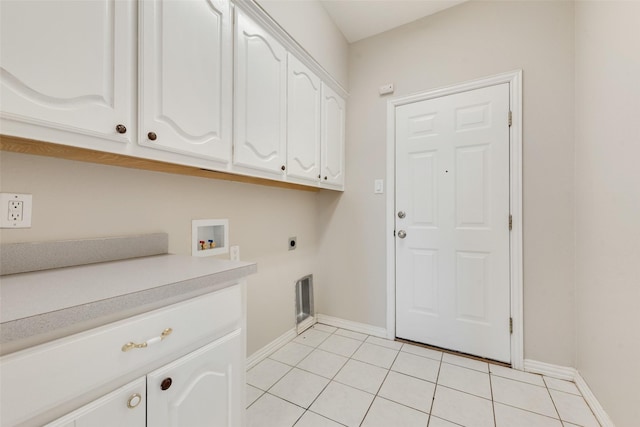 laundry area with cabinets, light tile patterned floors, hookup for a washing machine, and electric dryer hookup