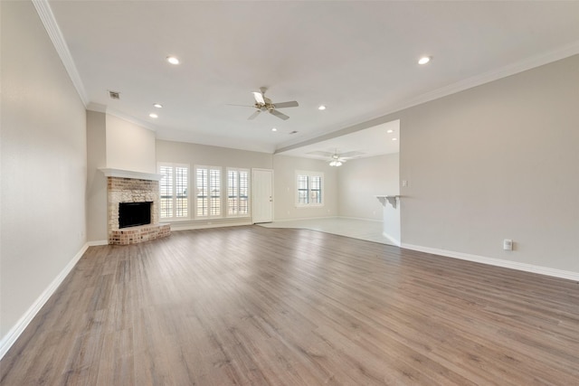 unfurnished living room with crown molding, ceiling fan, beam ceiling, and light wood-type flooring