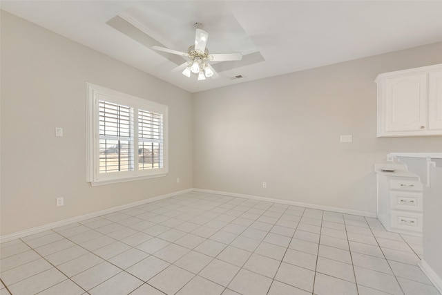 tiled empty room with ceiling fan