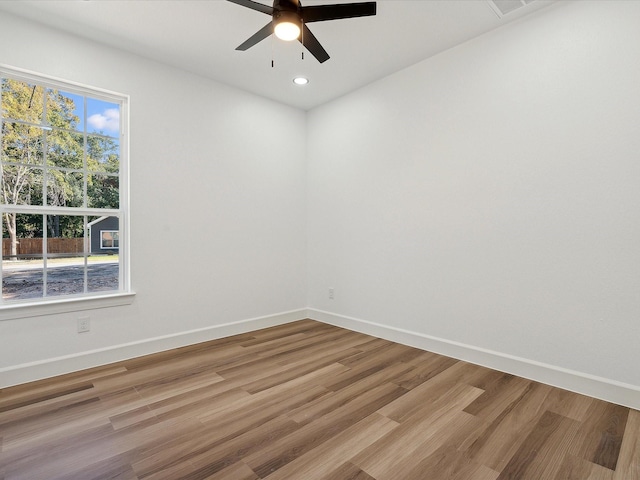 empty room with hardwood / wood-style flooring and ceiling fan