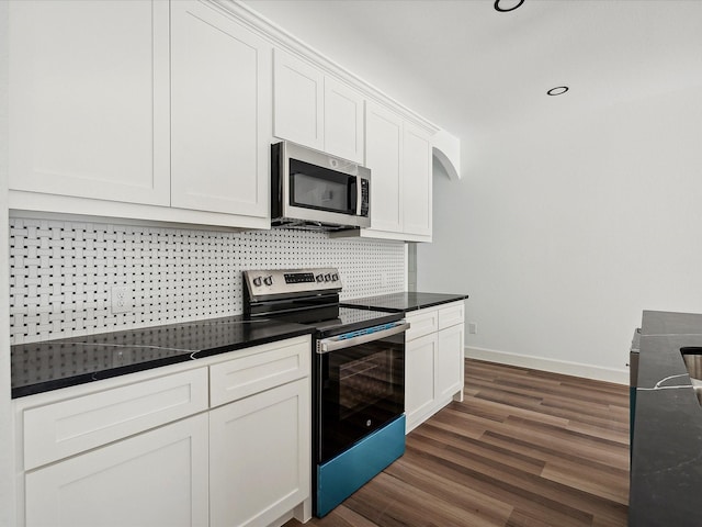 kitchen featuring stainless steel appliances, tasteful backsplash, dark hardwood / wood-style floors, and white cabinets