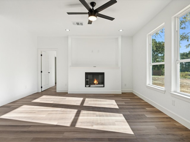 unfurnished living room with dark wood-type flooring and ceiling fan