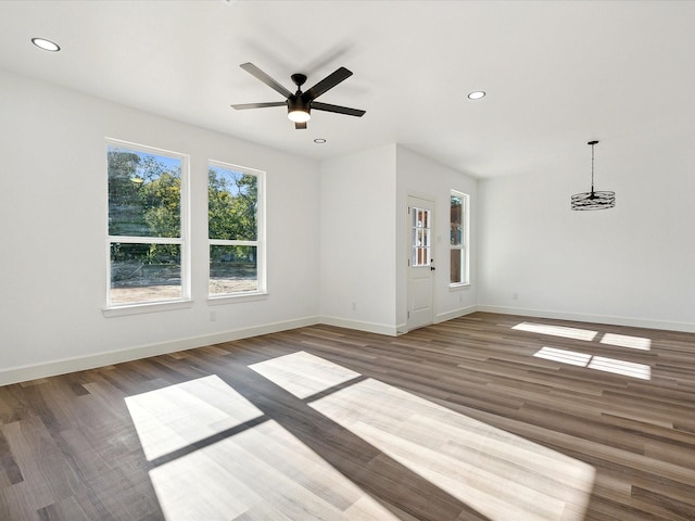 empty room featuring ceiling fan and dark hardwood / wood-style floors